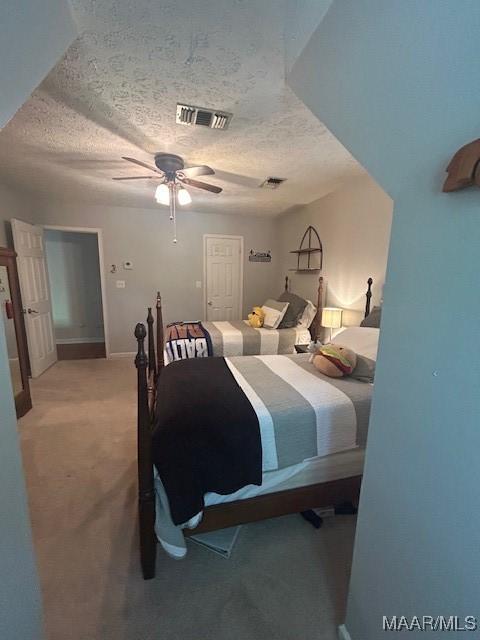 124 Reid Cir, Deatsville, AL 36022 - bedroom with a textured ceiling, light colored carpet, and a ceiling fan