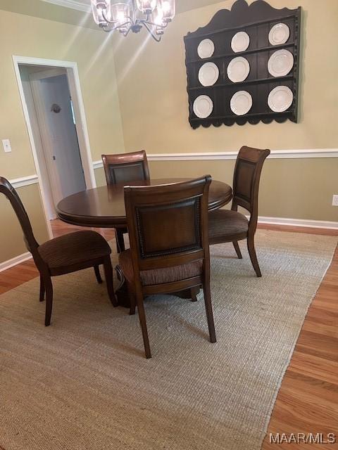 124 Reid Cir, Deatsville, AL 36022 - dining space featuring a chandelier and light wood finished floors
