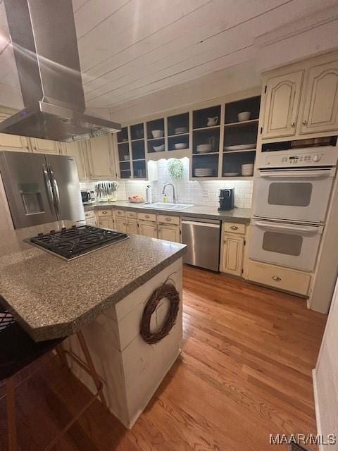 124 Reid Cir, Deatsville, AL 36022 - kitchen featuring appliances with stainless steel finishes, island range hood, light wood-style flooring, decorative backsplash, and open shelves
