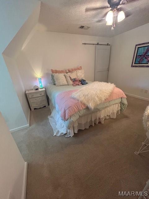 124 Reid Cir, Deatsville, AL 36022 - carpeted bedroom with a ceiling fan and a textured ceiling