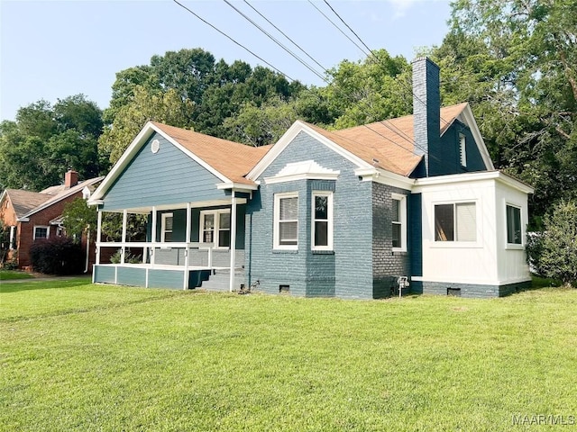 3155 Wilmington Rd, Montgomery, AL 36105 - rear view of house with covered porch, crawl space, a yard, a chimney, and brick siding