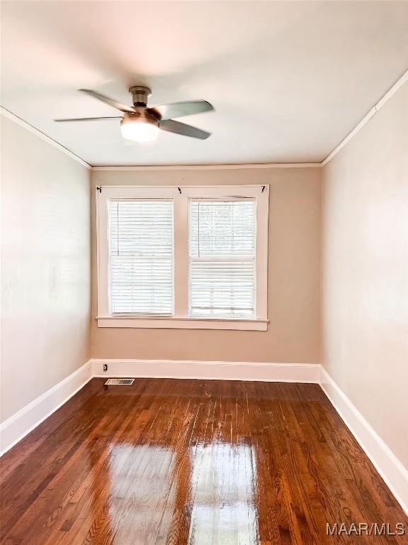 3155 Wilmington Rd, Montgomery, AL 36105 - spare room with crown molding, ceiling fan, and wood finished floors