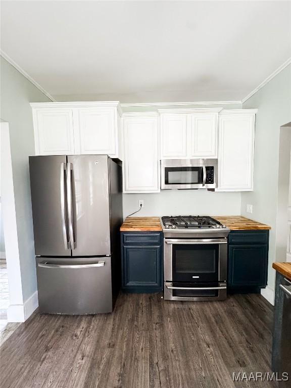 3155 Wilmington Rd, Montgomery, AL 36105 - kitchen featuring appliances with stainless steel finishes, butcher block counters, crown molding, dark wood-style floors, and white cabinets