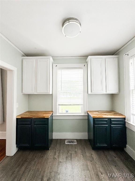 3155 Wilmington Rd, Montgomery, AL 36105 - kitchen with butcher block countertops, dark wood-style flooring, white cabinets, and ornamental molding