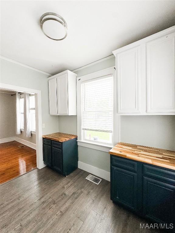 3155 Wilmington Rd, Montgomery, AL 36105 - kitchen featuring wooden counters, dark wood finished floors, ornamental molding, healthy amount of natural light, and white cabinetry