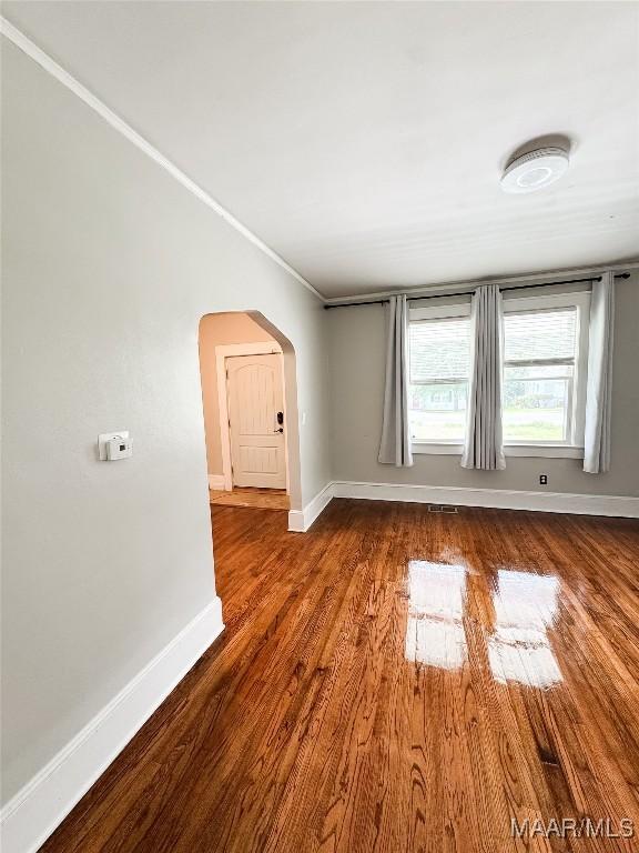 3155 Wilmington Rd, Montgomery, AL 36105 - spare room featuring arched walkways and wood finished floors