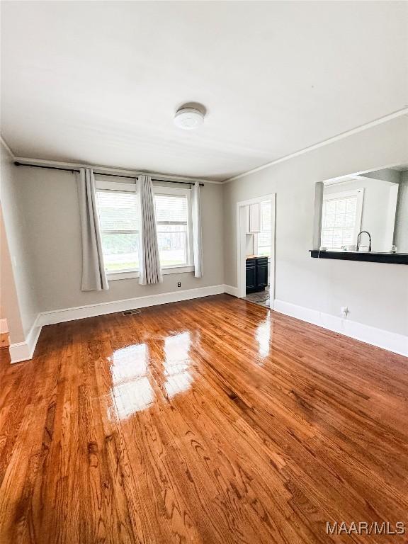 3155 Wilmington Rd, Montgomery, AL 36105 - unfurnished living room featuring wood finished floors and baseboards