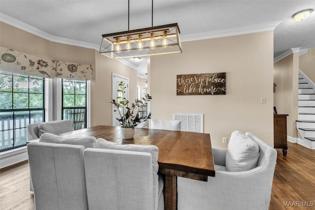 215 Hickory Rd, Titus, AL 36080 - dining space with ornamental molding, stairs, wood finished floors, and a chandelier