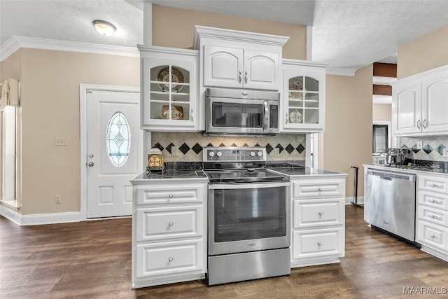 215 Hickory Rd, Titus, AL 36080 - kitchen with stainless steel appliances, white cabinets, glass insert cabinets, decorative backsplash, and dark wood-style floors