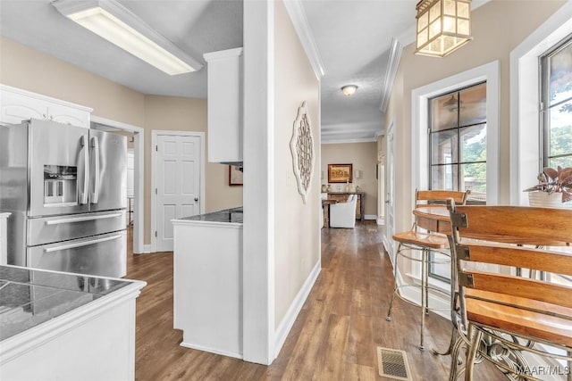 215 Hickory Rd, Titus, AL 36080 - kitchen with stainless steel refrigerator with ice dispenser, white cabinetry, ornamental molding, and wood finished floors
