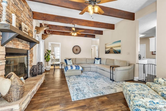 215 Hickory Rd, Titus, AL 36080 - living room featuring ceiling fan, beamed ceiling, dark wood-style flooring, and a fireplace