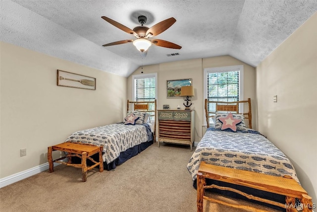 215 Hickory Rd, Titus, AL 36080 - bedroom with lofted ceiling, a textured ceiling, multiple windows, carpet, and a ceiling fan