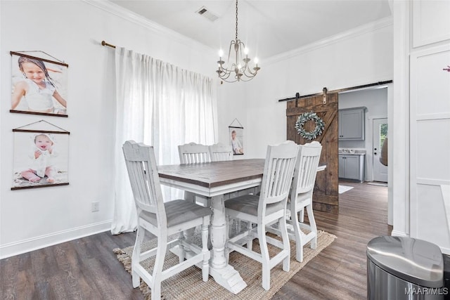 362 Driver Rd, Deatsville, AL 36022 - dining area with a chandelier, ornamental molding, a barn door, and wood finished floors