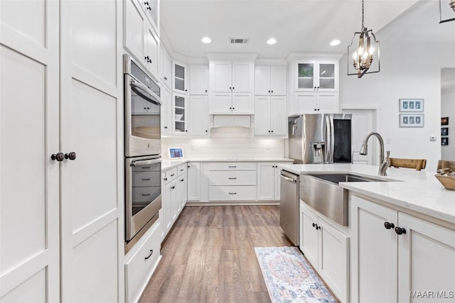 362 Driver Rd, Deatsville, AL 36022 - kitchen featuring appliances with stainless steel finishes, recessed lighting, light wood finished floors, hanging light fixtures, and white cabinets