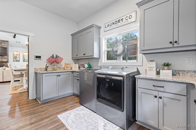 362 Driver Rd, Deatsville, AL 36022 - laundry area with cabinet space, washer and clothes dryer, and light wood-style flooring