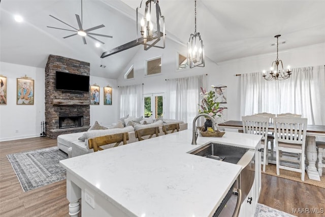 362 Driver Rd, Deatsville, AL 36022 - kitchen featuring a chandelier, open floor plan, dark wood-style flooring, a fireplace, and high vaulted ceiling