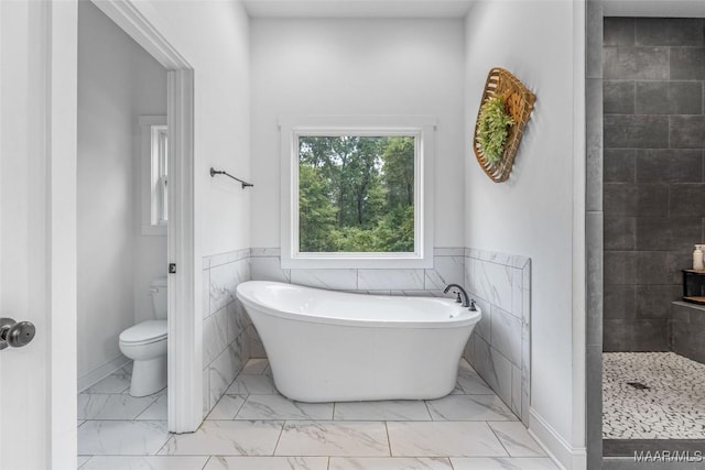 362 Driver Rd, Deatsville, AL 36022 - bathroom with a soaking tub, marble finish flooring, tile walls, a wainscoted wall, and a tile shower