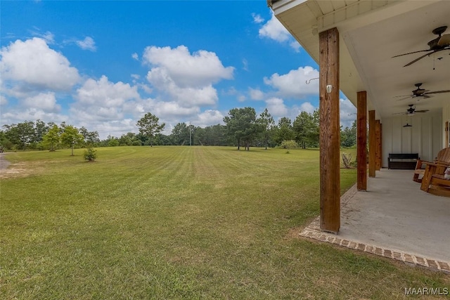 362 Driver Rd, Deatsville, AL 36022 - view of green lawn featuring ceiling fan, a patio, and view of wooded area