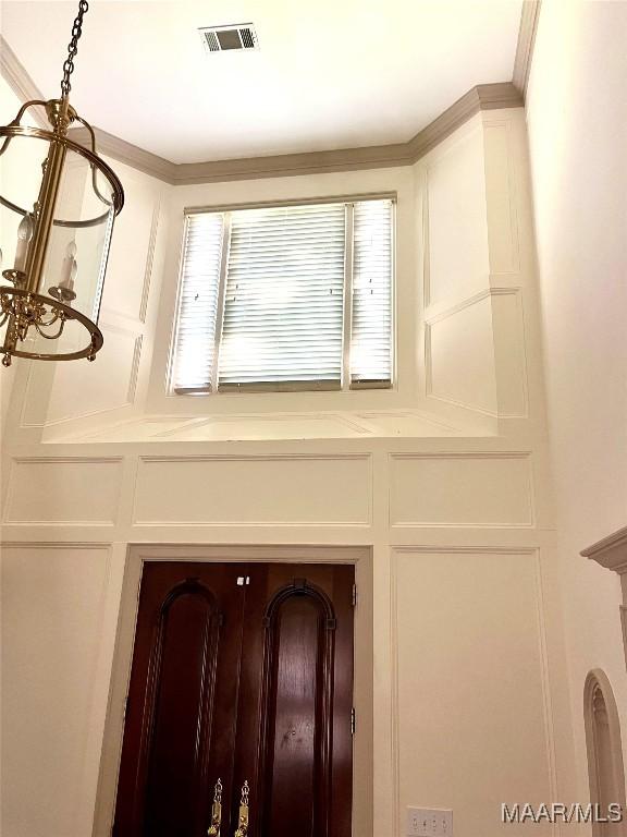9858 Wynchase Cir, Montgomery, AL 36117 - detailed view of a decorative wall, a chandelier, and crown molding