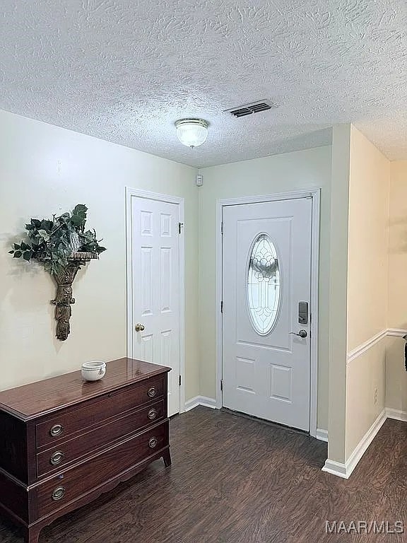 312 Rebekah Ln, Montgomery, AL 36109 - foyer featuring dark wood finished floors and a textured ceiling