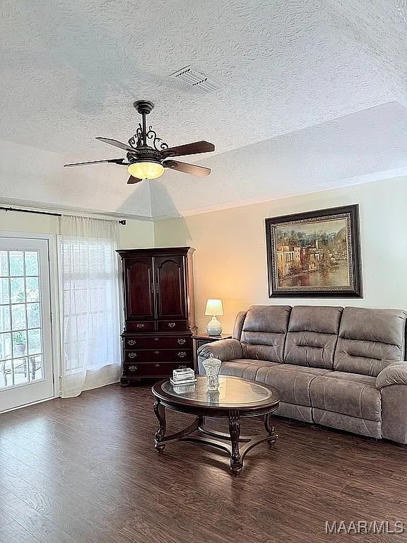 312 Rebekah Ln, Montgomery, AL 36109 - living room featuring dark wood-type flooring, a textured ceiling, and a ceiling fan