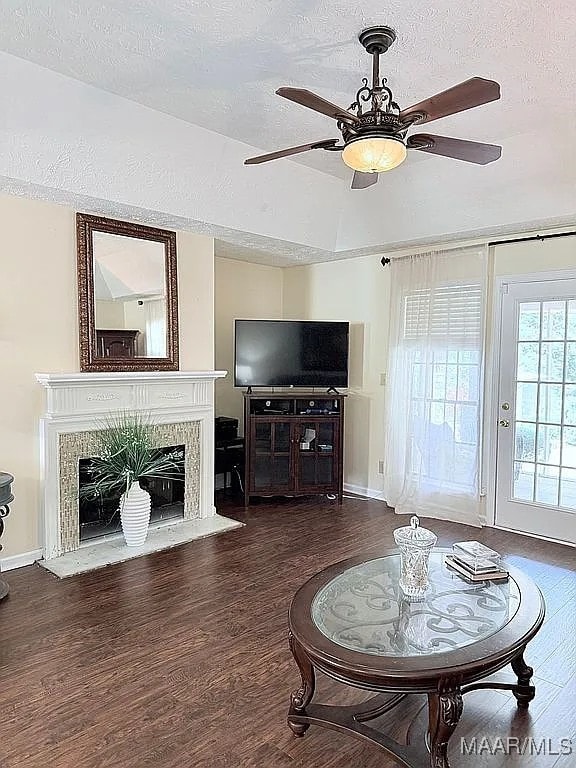 312 Rebekah Ln, Montgomery, AL 36109 - living area featuring a textured ceiling, wood finished floors, a ceiling fan, and a premium fireplace
