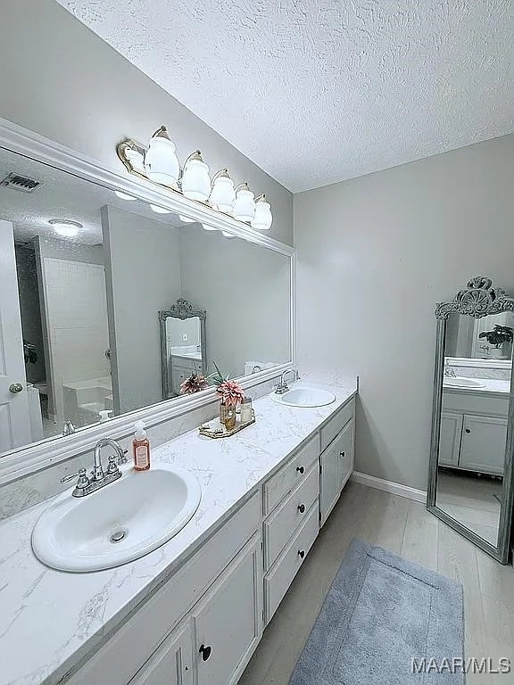 312 Rebekah Ln, Montgomery, AL 36109 - bathroom with double vanity and a textured ceiling