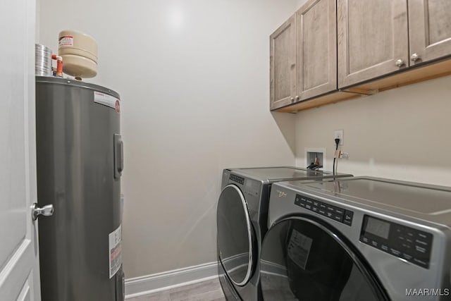 174 Shadow Wood Ln, Wetumpka, AL 36092 - washroom featuring water heater, washing machine and dryer, cabinet space, and wood finished floors