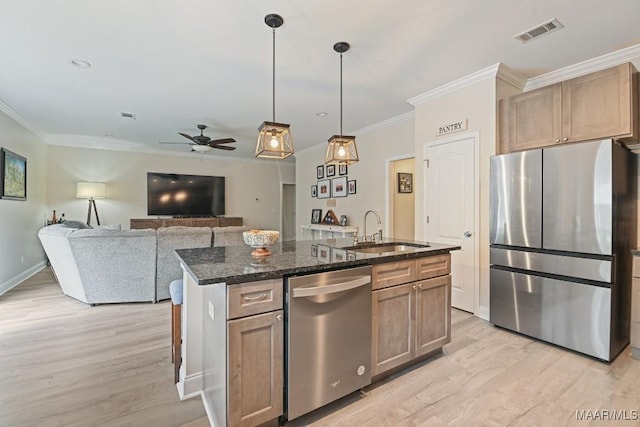 174 Shadow Wood Ln, Wetumpka, AL 36092 - kitchen with appliances with stainless steel finishes, a ceiling fan, crown molding, light wood-style flooring, and dark stone countertops