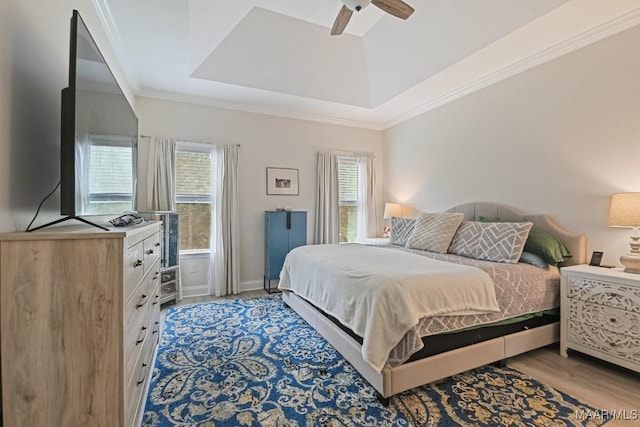174 Shadow Wood Ln, Wetumpka, AL 36092 - bedroom featuring ornamental molding, light wood-style floors, ceiling fan, and a raised ceiling