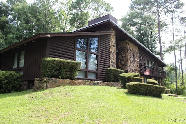 168 County Road 563, Valley Grande, AL 36701 - view of property exterior with a lawn, a chimney, and stone siding