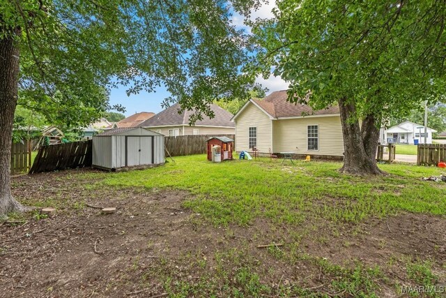 1018 Austin St, Wetumpka, AL 36092 - rear view of property featuring a storage shed and a fenced backyard