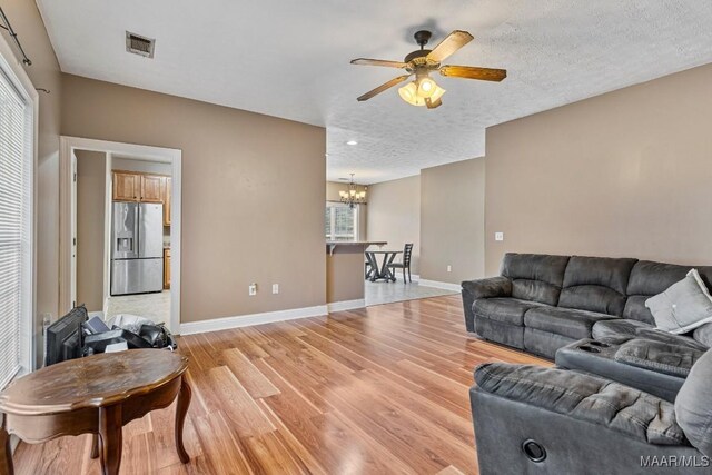 1018 Austin St, Wetumpka, AL 36092 - living area with a ceiling fan, a chandelier, light wood-style floors, recessed lighting, and a textured ceiling