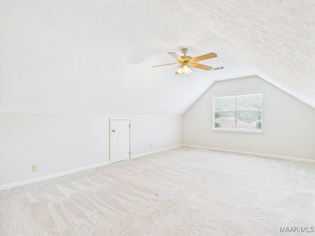 7467 Old Pump Rd, Montgomery, AL 36117 - bonus room featuring light colored carpet, vaulted ceiling, a ceiling fan, and a textured ceiling