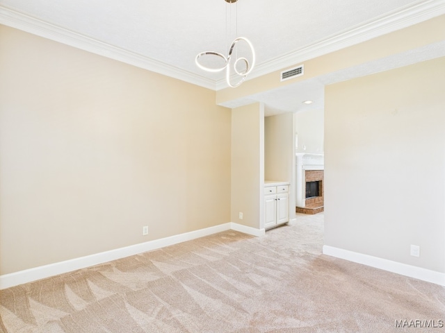 7467 Old Pump Rd, Montgomery, AL 36117 - empty room featuring crown molding, light colored carpet, a chandelier, and a brick fireplace
