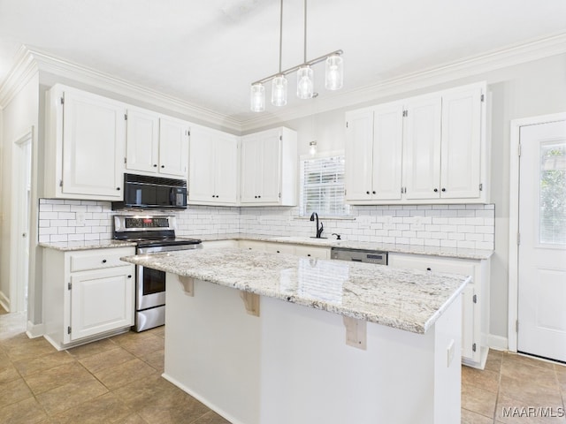 7467 Old Pump Rd, Montgomery, AL 36117 - kitchen with electric range, black microwave, white cabinets, a kitchen island, and tasteful backsplash