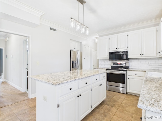 7467 Old Pump Rd, Montgomery, AL 36117 - kitchen featuring appliances with stainless steel finishes, crown molding, a center island, tasteful backsplash, and white cabinetry