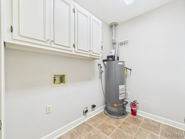 7467 Old Pump Rd, Montgomery, AL 36117 - laundry room featuring gas water heater, hookup for a washing machine, hookup for an electric dryer, cabinet space, and tile patterned floors