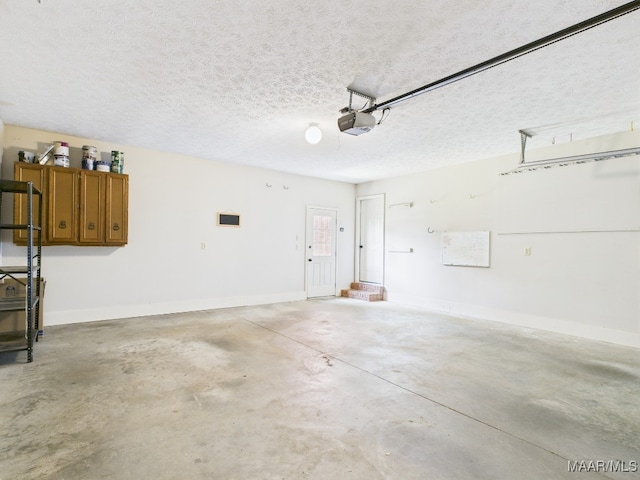 7467 Old Pump Rd, Montgomery, AL 36117 - garage featuring a garage door opener and baseboards