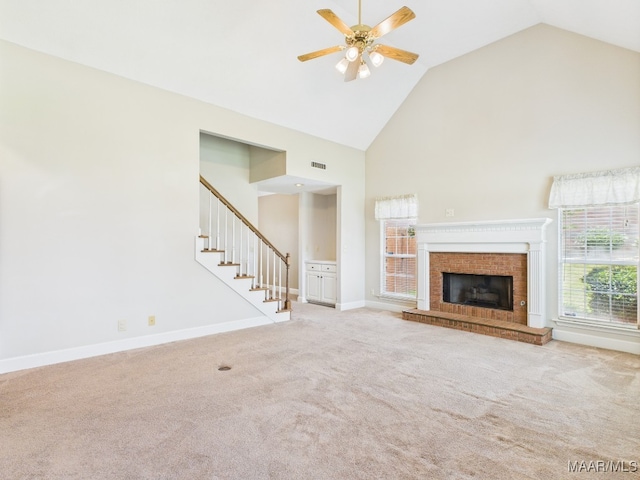 7467 Old Pump Rd, Montgomery, AL 36117 - unfurnished living room with a ceiling fan, high vaulted ceiling, stairs, carpet, and a brick fireplace