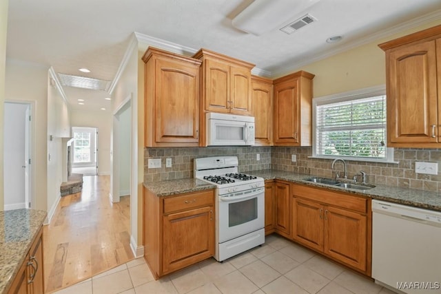2196 N Ann Ave, Tallassee, AL 36078 - kitchen featuring white appliances, crown molding, healthy amount of natural light, light stone countertops, and tasteful backsplash