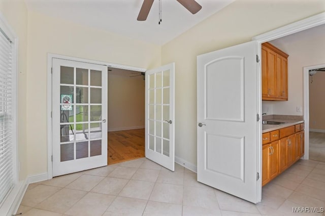 2196 N Ann Ave, Tallassee, AL 36078 - kitchen featuring french doors, ceiling fan, light countertops, and brown cabinetry