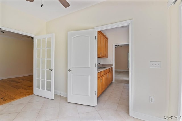 2196 N Ann Ave, Tallassee, AL 36078 - kitchen featuring ceiling fan, light countertops, brown cabinets, and light tile patterned floors