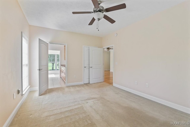 2196 N Ann Ave, Tallassee, AL 36078 - unfurnished bedroom featuring light carpet, connected bathroom, and ceiling fan