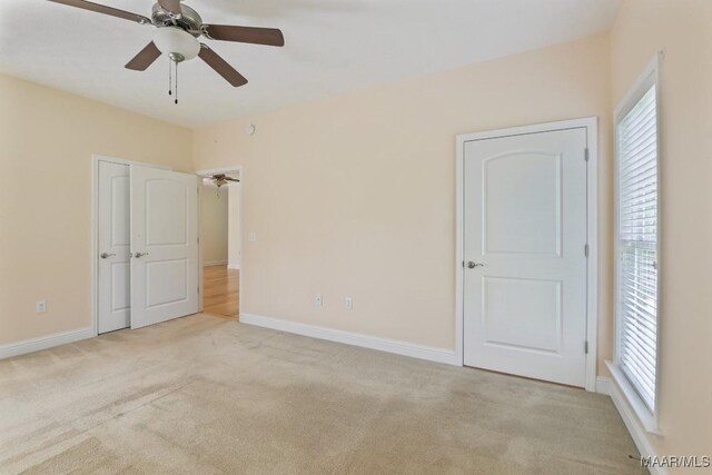 2196 N Ann Ave, Tallassee, AL 36078 - unfurnished bedroom with light colored carpet, multiple windows, and a ceiling fan