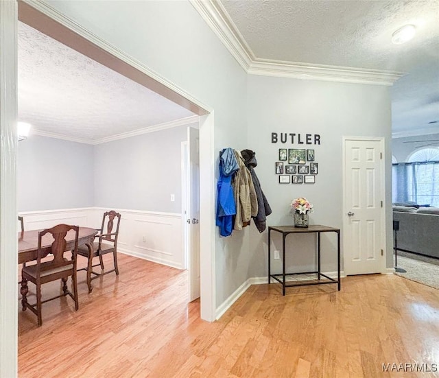 7908 Arrowhead Forest Ct, Montgomery, AL 36117 - hallway featuring a textured ceiling, light wood-style floors, crown molding, and a wainscoted wall