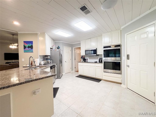 7908 Arrowhead Forest Ct, Montgomery, AL 36117 - kitchen with appliances with stainless steel finishes, crown molding, decorative backsplash, dark stone countertops, and a ceiling fan