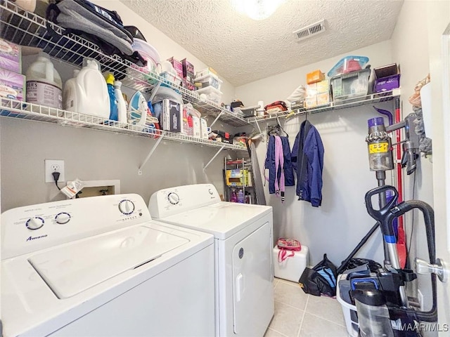 7908 Arrowhead Forest Ct, Montgomery, AL 36117 - laundry room with washer and dryer, a textured ceiling, and light tile patterned flooring