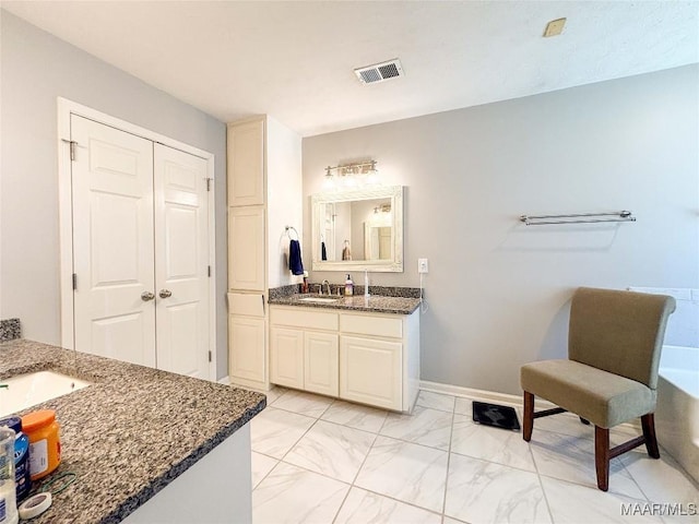 7908 Arrowhead Forest Ct, Montgomery, AL 36117 - full bathroom with two vanities and marble look tile flooring
