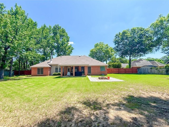 7908 Arrowhead Forest Ct, Montgomery, AL 36117 - back of property with an outdoor fire pit, a fenced backyard, a patio, and brick siding